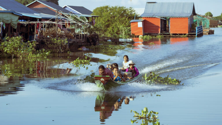 Traditional floating houses at Mechrey Floating Village on Tonle Sap Lake near Siem Reap Cambodia