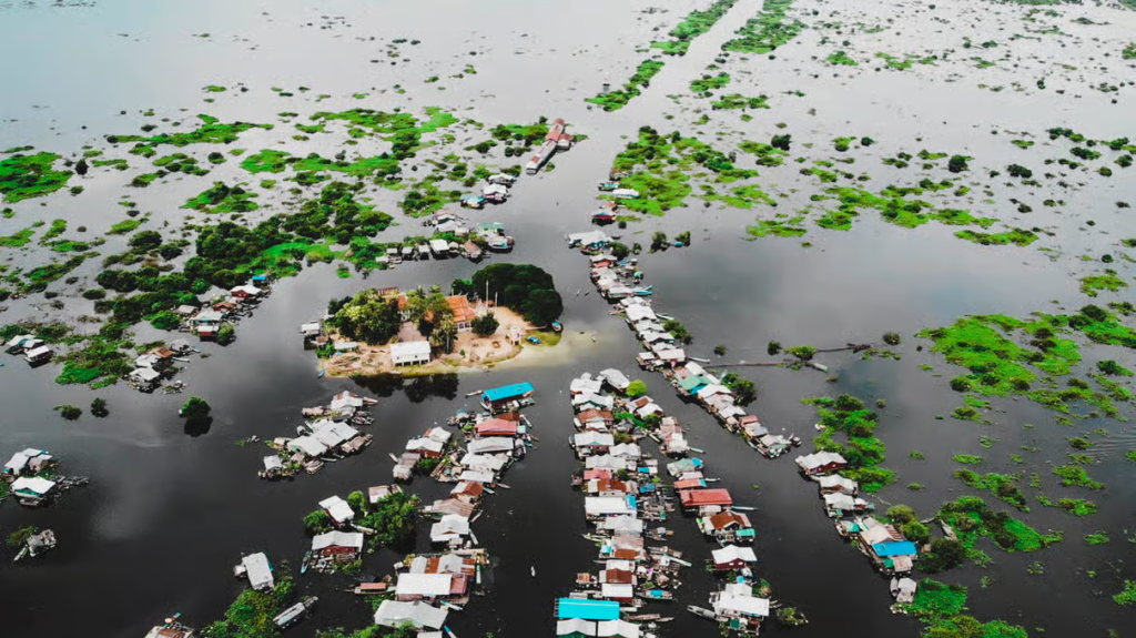 Traditional boat tour through Kompong Phluk floating village and flooded forest on Tonle Sap Lake near Siem Reap Cambodia